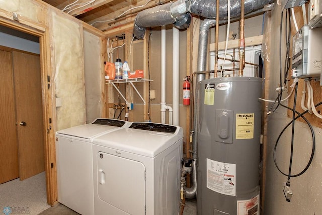 clothes washing area featuring washer and clothes dryer and water heater