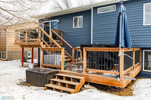 snow covered property featuring a deck