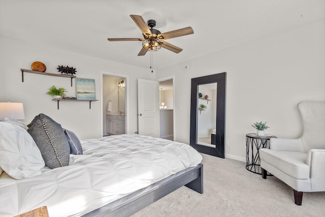 bedroom with connected bathroom, baseboards, ceiling fan, and carpet floors