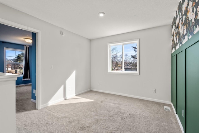 interior space with visible vents, baseboards, and a textured ceiling