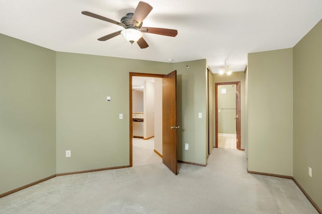 spare room with light colored carpet and ceiling fan