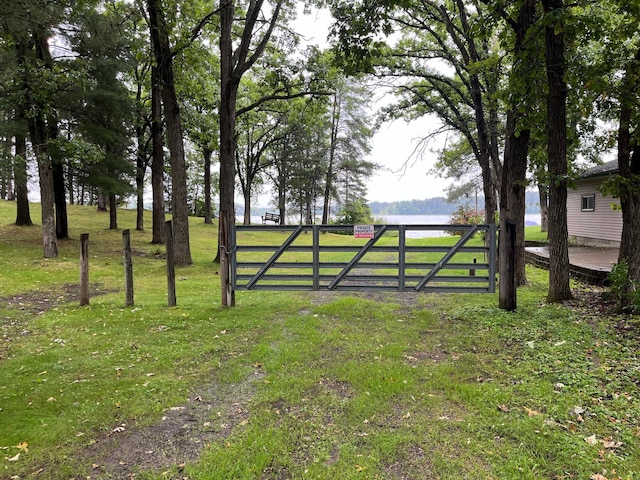 view of gate featuring a lawn