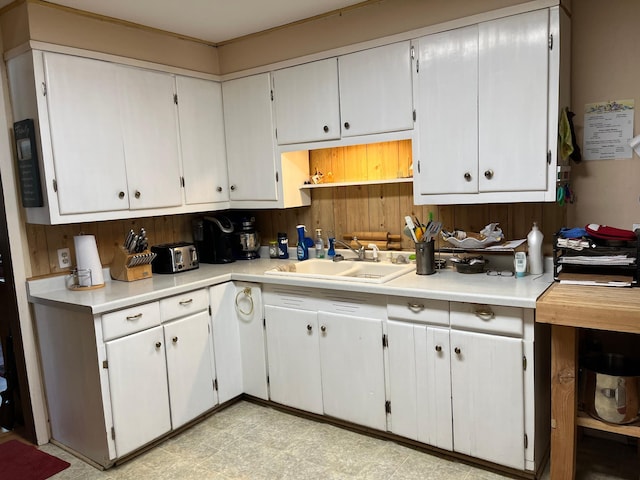 kitchen featuring sink and white cabinets