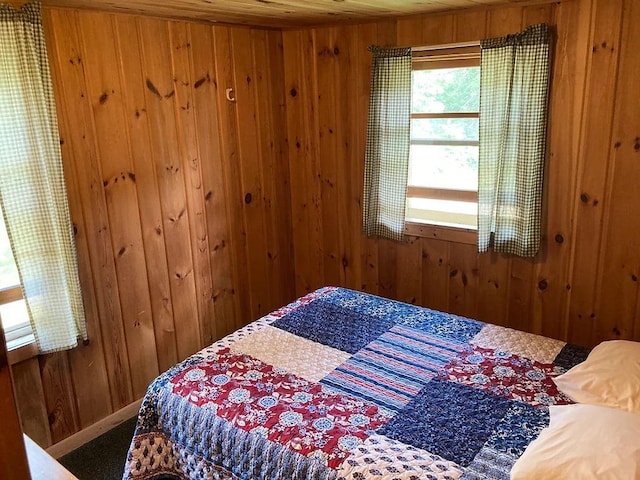 bedroom with wood walls