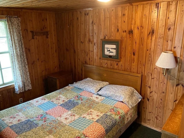 bedroom featuring wooden walls and wooden ceiling