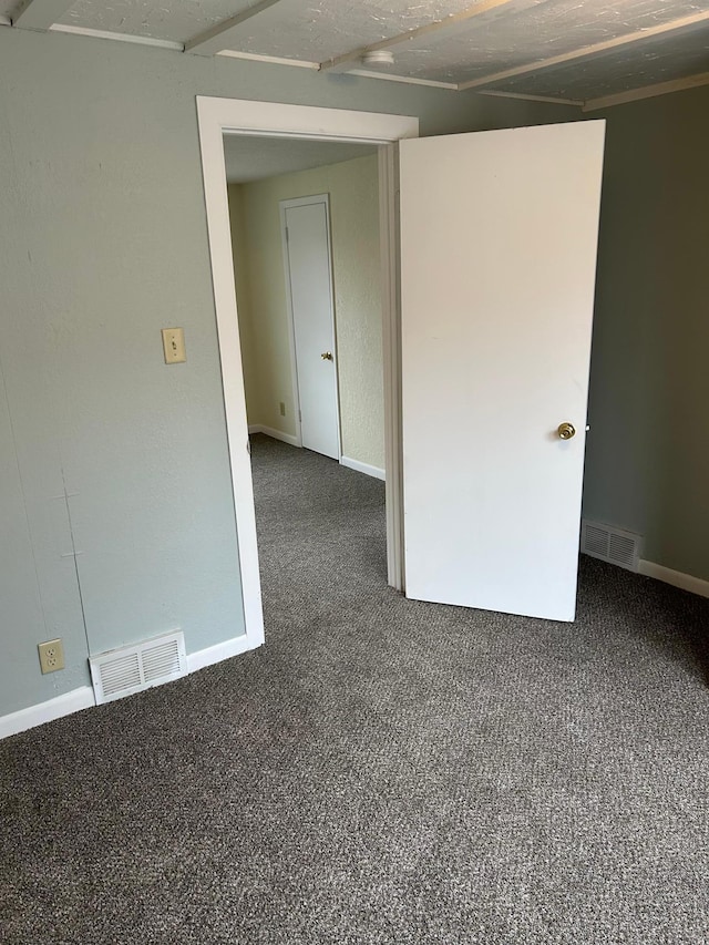 empty room with dark carpet