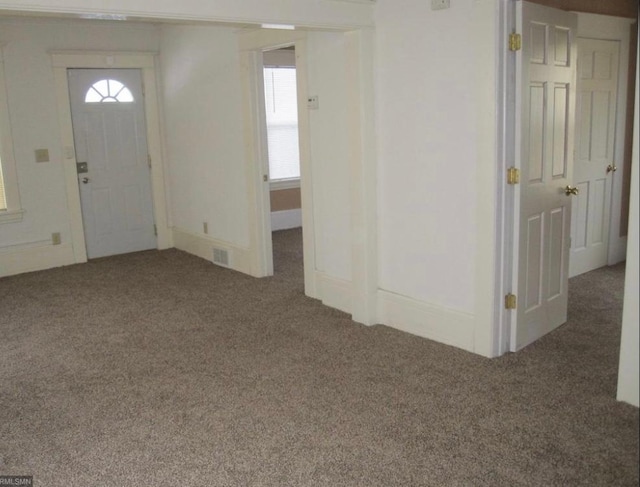 view of carpeted foyer