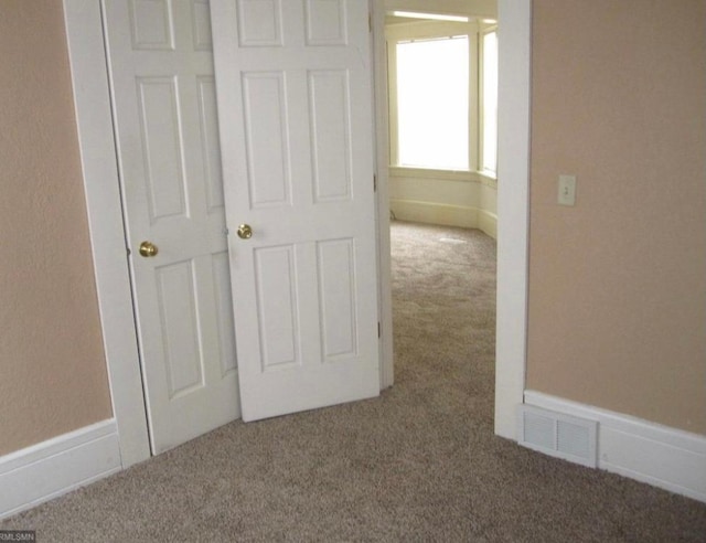 hallway with carpet flooring