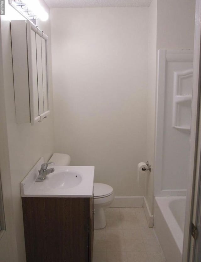 bathroom featuring vanity, a bath, a textured ceiling, and toilet