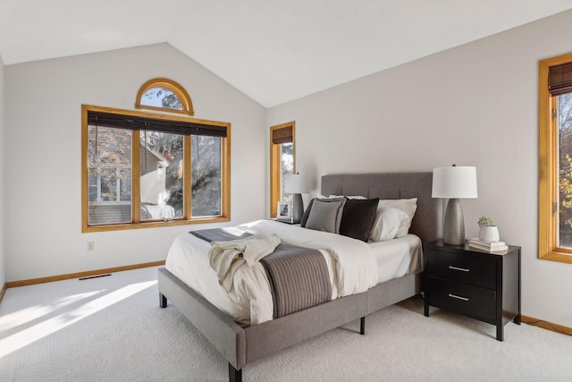 bedroom featuring lofted ceiling and light carpet