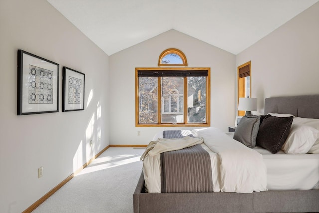 carpeted bedroom featuring lofted ceiling