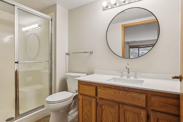 bathroom with vanity, toilet, and walk in shower