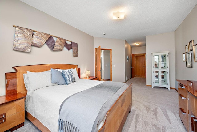 bedroom with light carpet and a textured ceiling