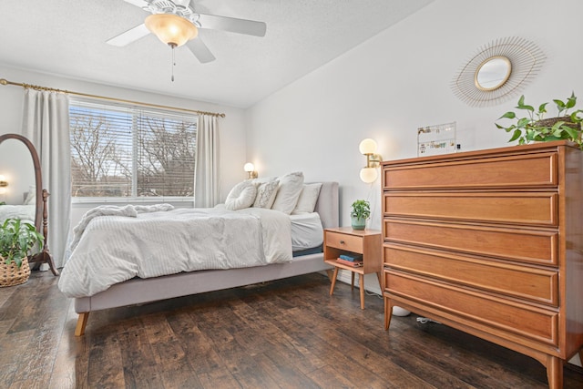 bedroom with dark hardwood / wood-style floors and ceiling fan