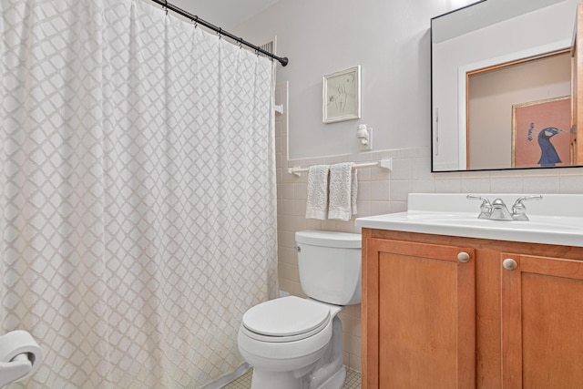 bathroom with tile walls, vanity, curtained shower, and toilet