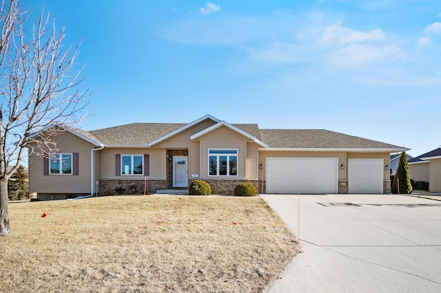 ranch-style home with a garage and a front lawn