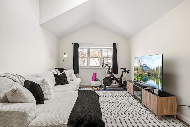 living area with lofted ceiling and baseboards