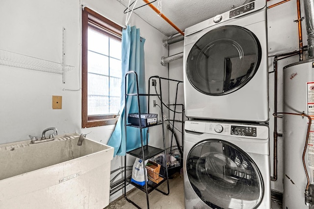 laundry room featuring stacked washer and dryer, a sink, a textured ceiling, gas water heater, and laundry area