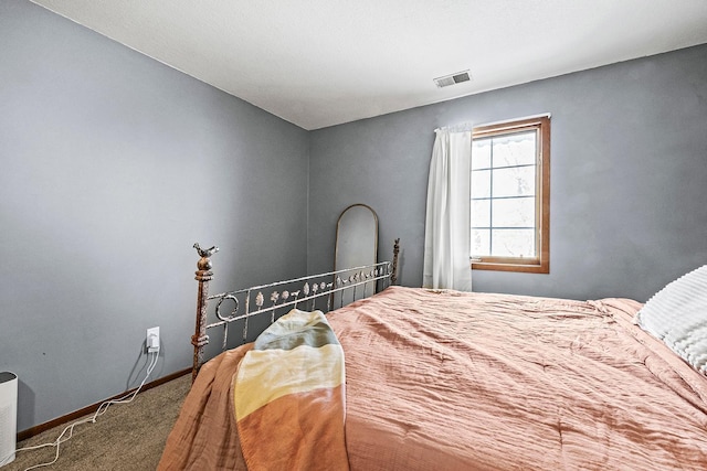 bedroom with carpet flooring, baseboards, and visible vents