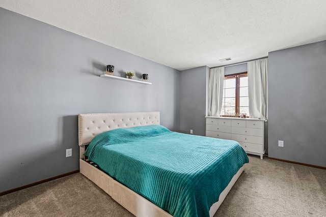 bedroom with visible vents, a textured ceiling, baseboards, and carpet floors