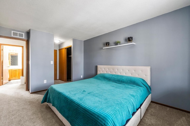 carpeted bedroom with baseboards, visible vents, and a closet