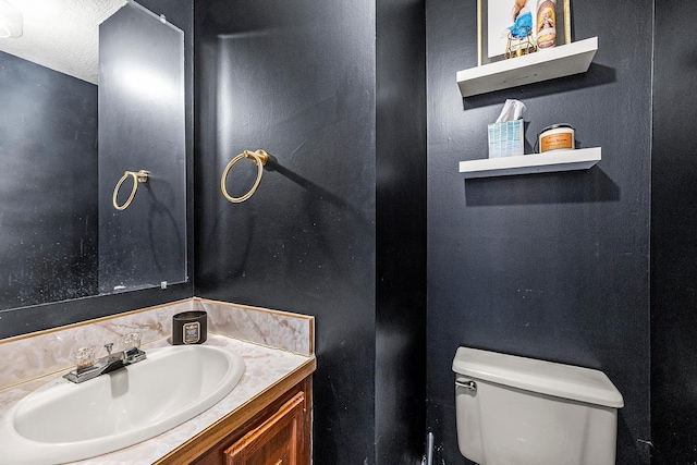 bathroom with toilet and vanity