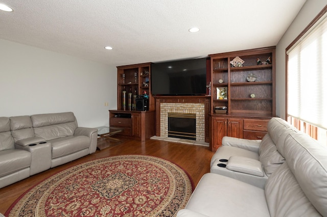 living room featuring dark hardwood / wood-style flooring and a fireplace