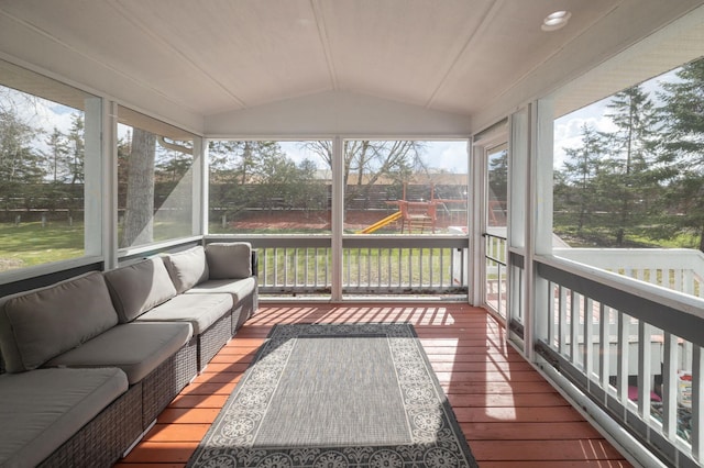 sunroom featuring vaulted ceiling