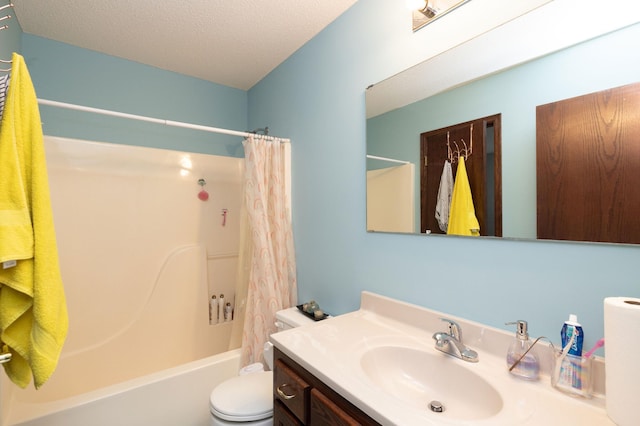 full bathroom featuring vanity, shower / bath combo, a textured ceiling, and toilet