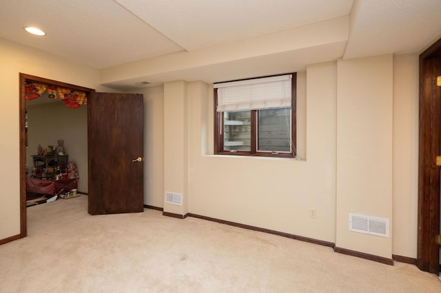 carpeted empty room featuring a textured ceiling