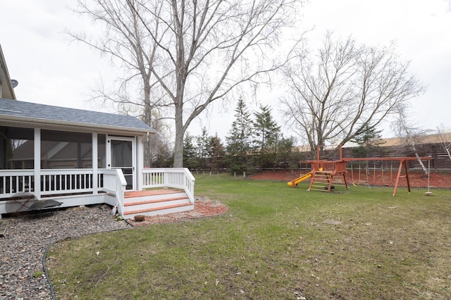 view of yard featuring a playground and a sunroom