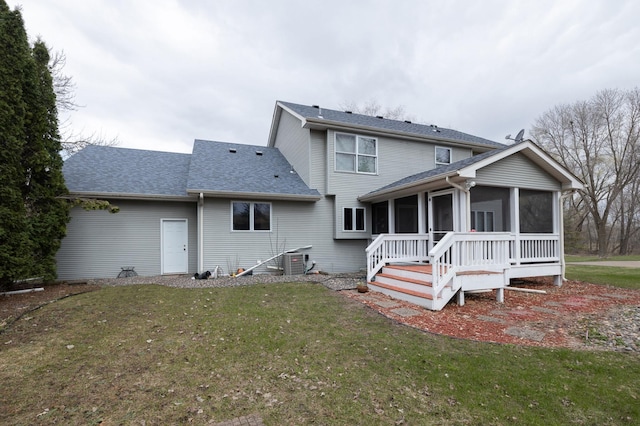 rear view of property featuring central AC unit, a yard, and a sunroom