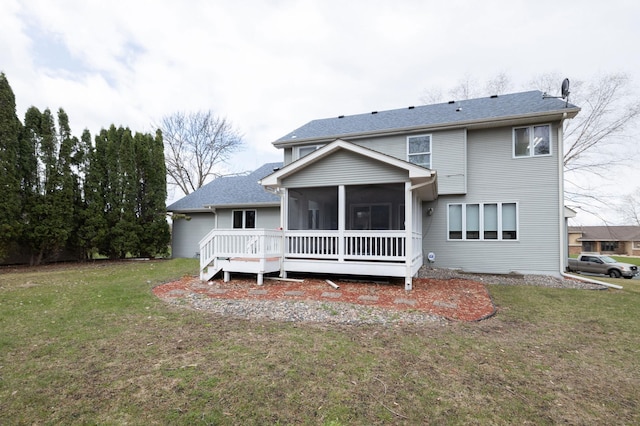 back of house featuring a wooden deck, a sunroom, and a lawn