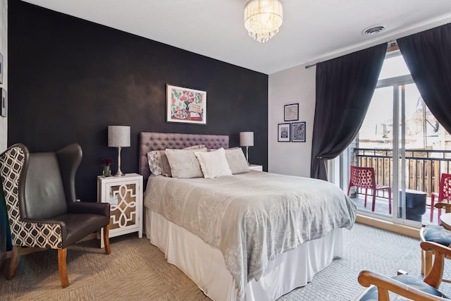 bedroom featuring a notable chandelier, light colored carpet, an accent wall, visible vents, and access to exterior