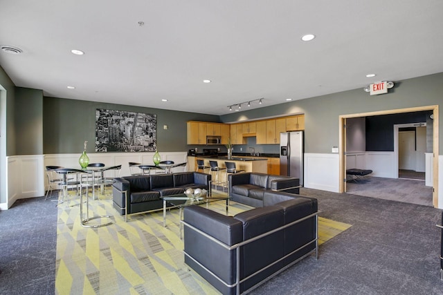 living area featuring light carpet, wainscoting, visible vents, and recessed lighting