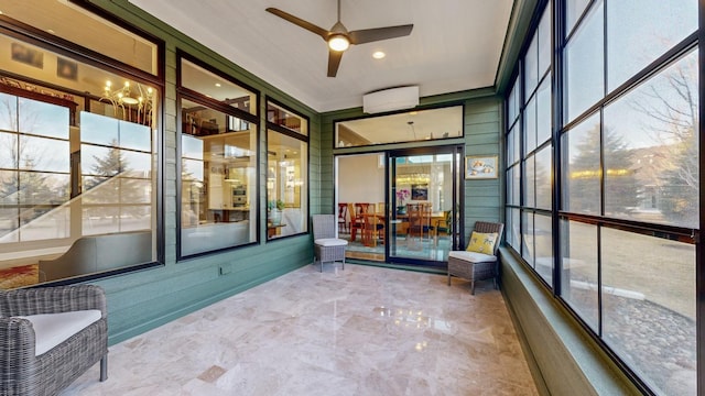 unfurnished sunroom with ceiling fan