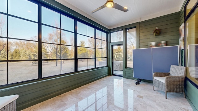 sunroom featuring ceiling fan