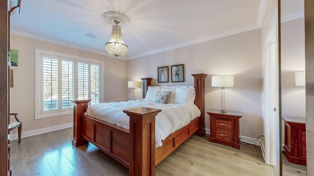 bedroom with a notable chandelier, crown molding, and light wood-type flooring