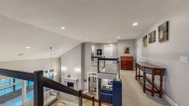 workout room featuring vaulted ceiling, an inviting chandelier, carpet floors, and a textured ceiling