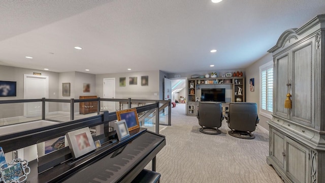 game room featuring light colored carpet and a textured ceiling