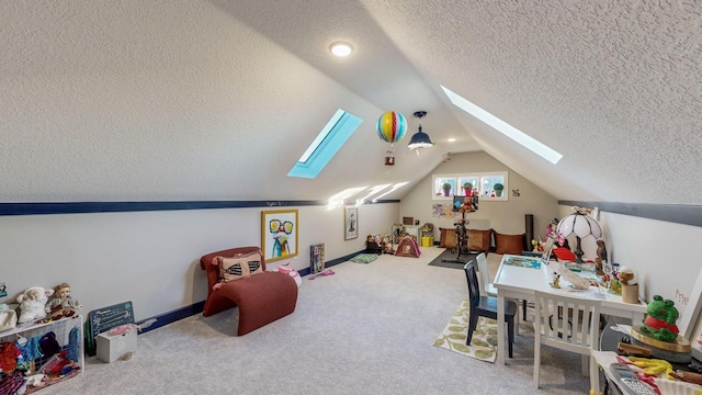 game room with lofted ceiling with skylight, a textured ceiling, and carpet flooring