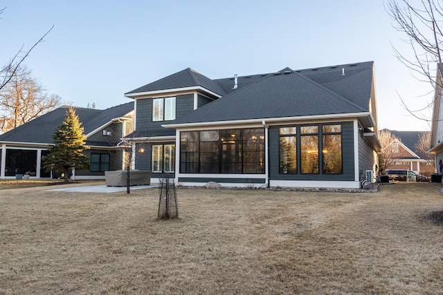 rear view of house featuring a patio area and a lawn