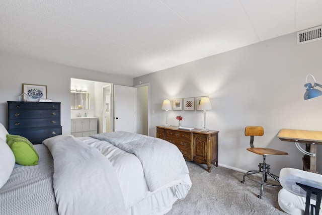 bedroom featuring visible vents, light carpet, baseboards, and connected bathroom