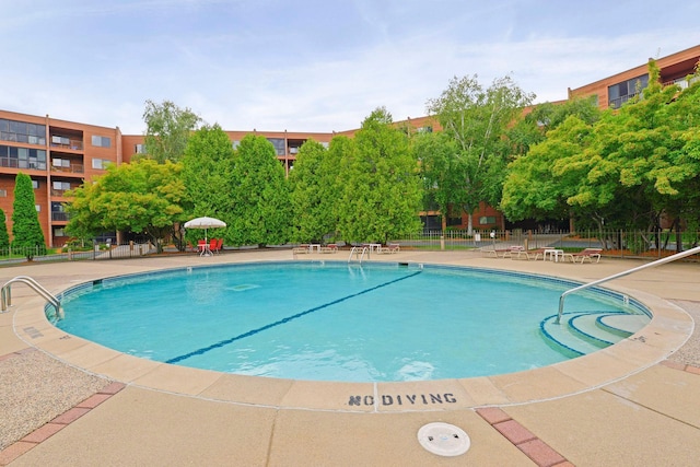 community pool featuring a patio area and fence