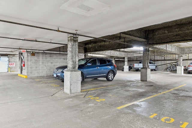 parking garage featuring concrete block wall