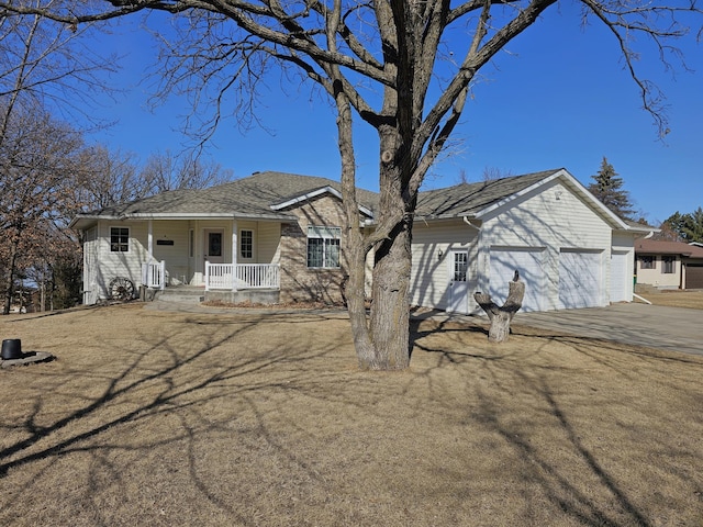 view of front of house featuring an attached garage, covered porch, and driveway