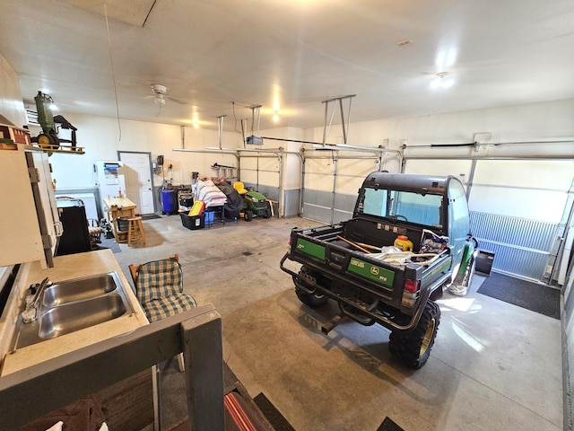 garage with a garage door opener and a sink