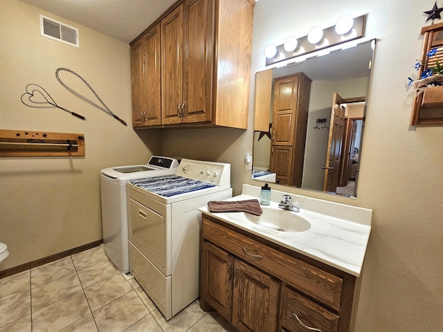 8785 Ilex Pl NW, Rice, MN 56367 - washroom featuring washing machine and dryer, light tile patterned floors, a textured ceiling, and baseboards