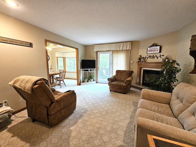 8785 Ilex Pl NW, Rice, MN 56367 - carpeted living area with a fireplace with raised hearth, a textured ceiling, and baseboards