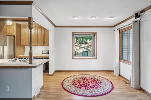 kitchen featuring crown molding, stainless steel fridge, and light wood-type flooring